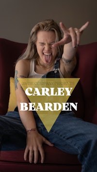 a woman sitting in a chair with the words carley bearden