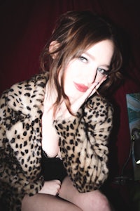 a woman wearing a leopard coat