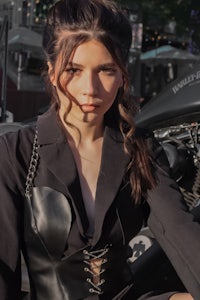a woman is sitting on a motorcycle