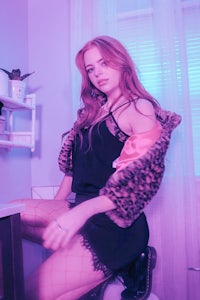 a woman sitting on a toilet in a bathroom