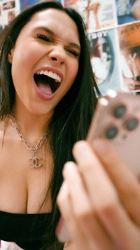 a woman is taking a picture of herself with a cell phone